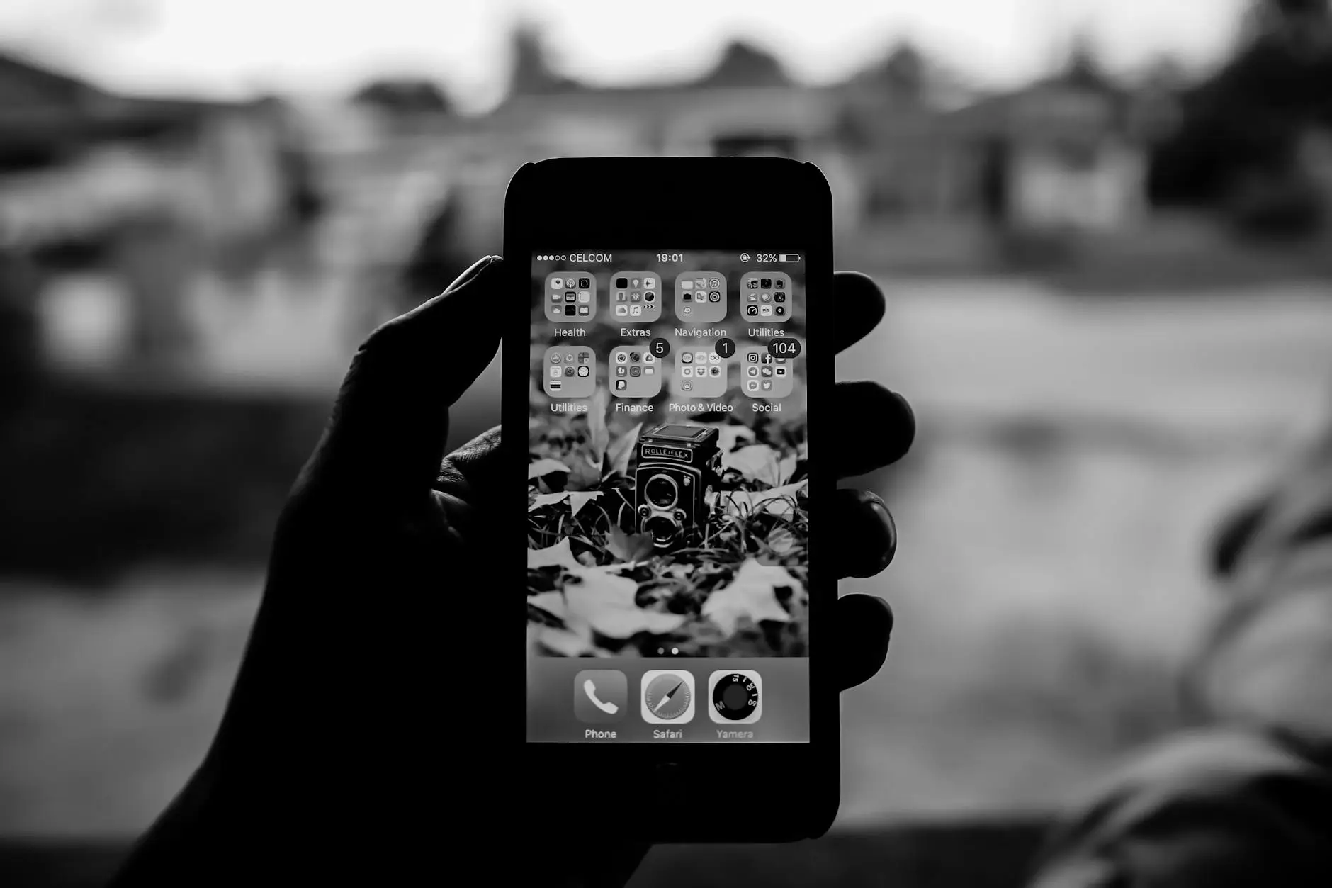 grayscale person holding smartphone